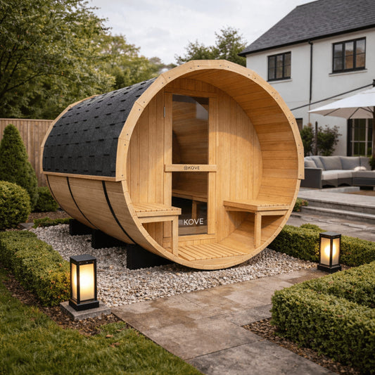 Wooden barrel-shaped outdoor sauna with 'Kove' branding in a garden setting.