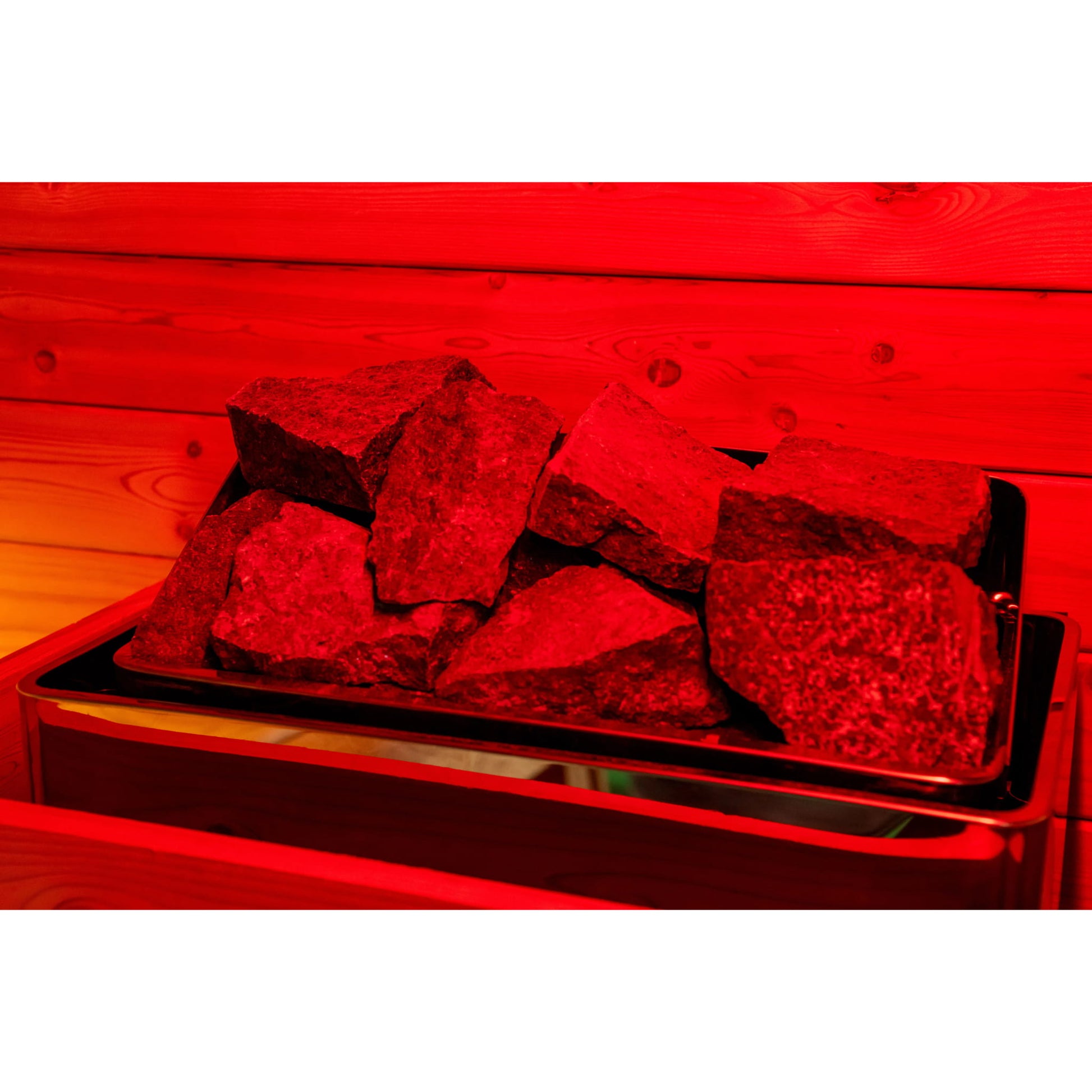 Stones on a grill with a red glow on a wooden background