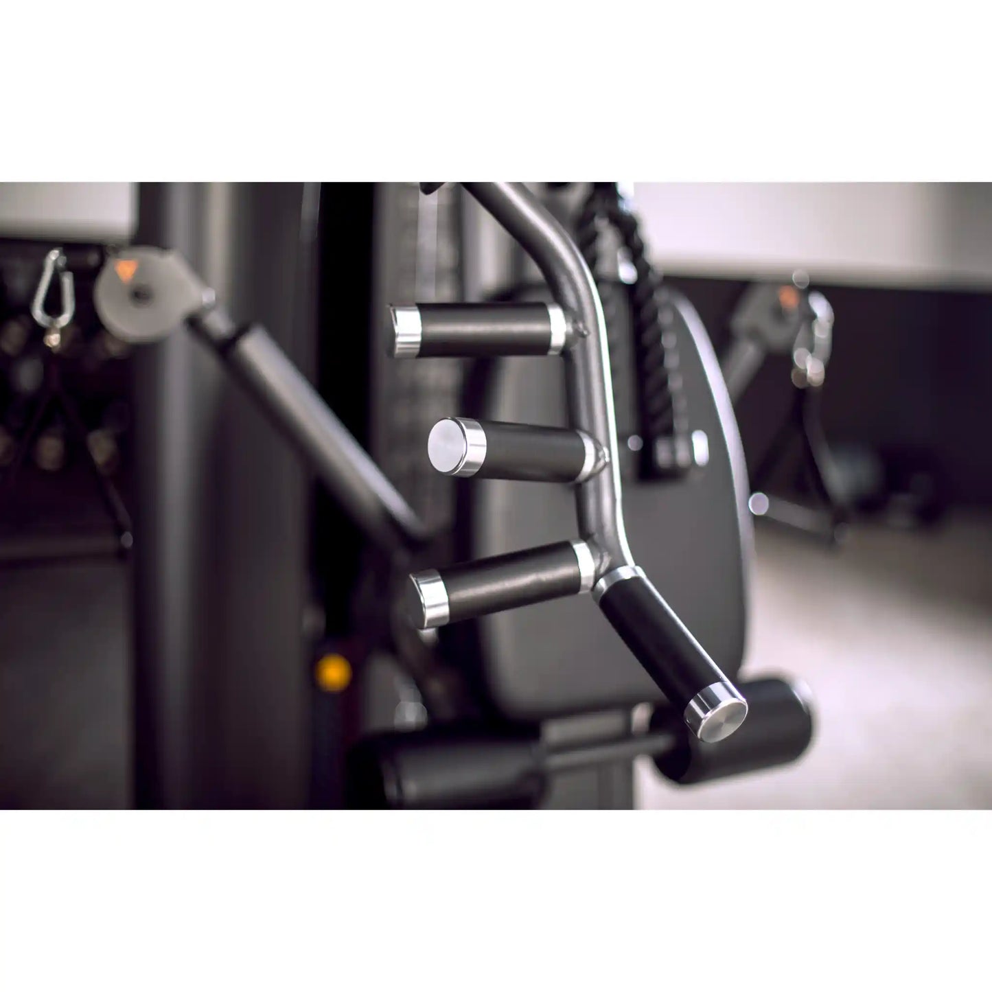 Close-up of multi gym handles and control levers with a blurred background