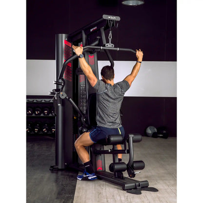 Man using lat pulldown function on multi gym
