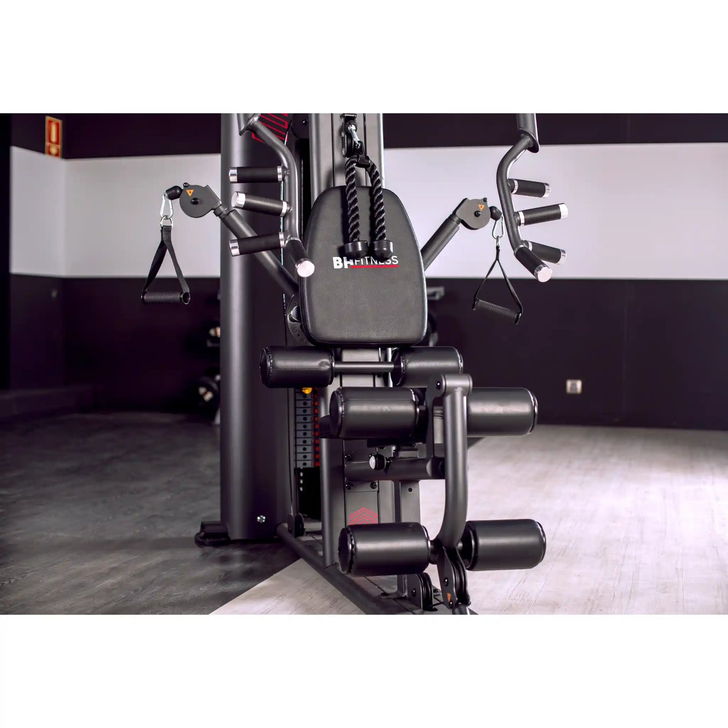 Multi Gym machine with 'BH Fitness' branding in a gym setting