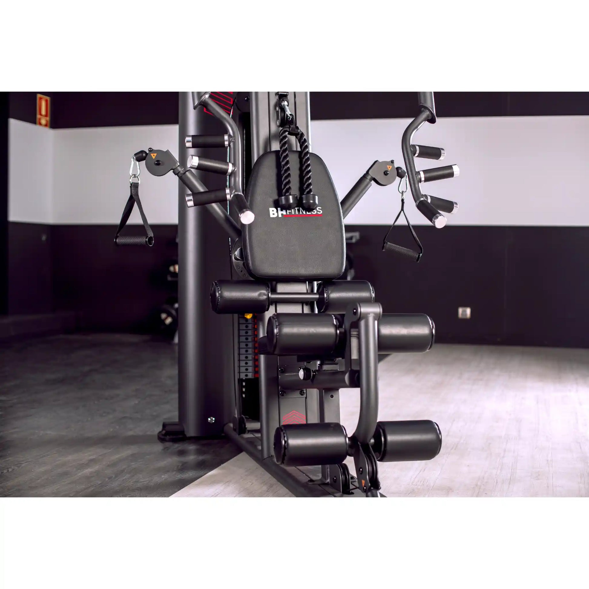 Multi Gym machine with 'BH Fitness' branding in a gym setting
