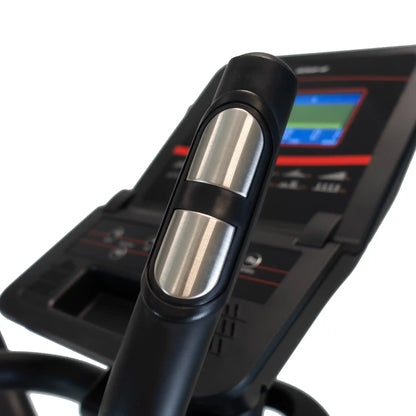 Close-up of a black cross trainer handles with sensors and digital display on a white background