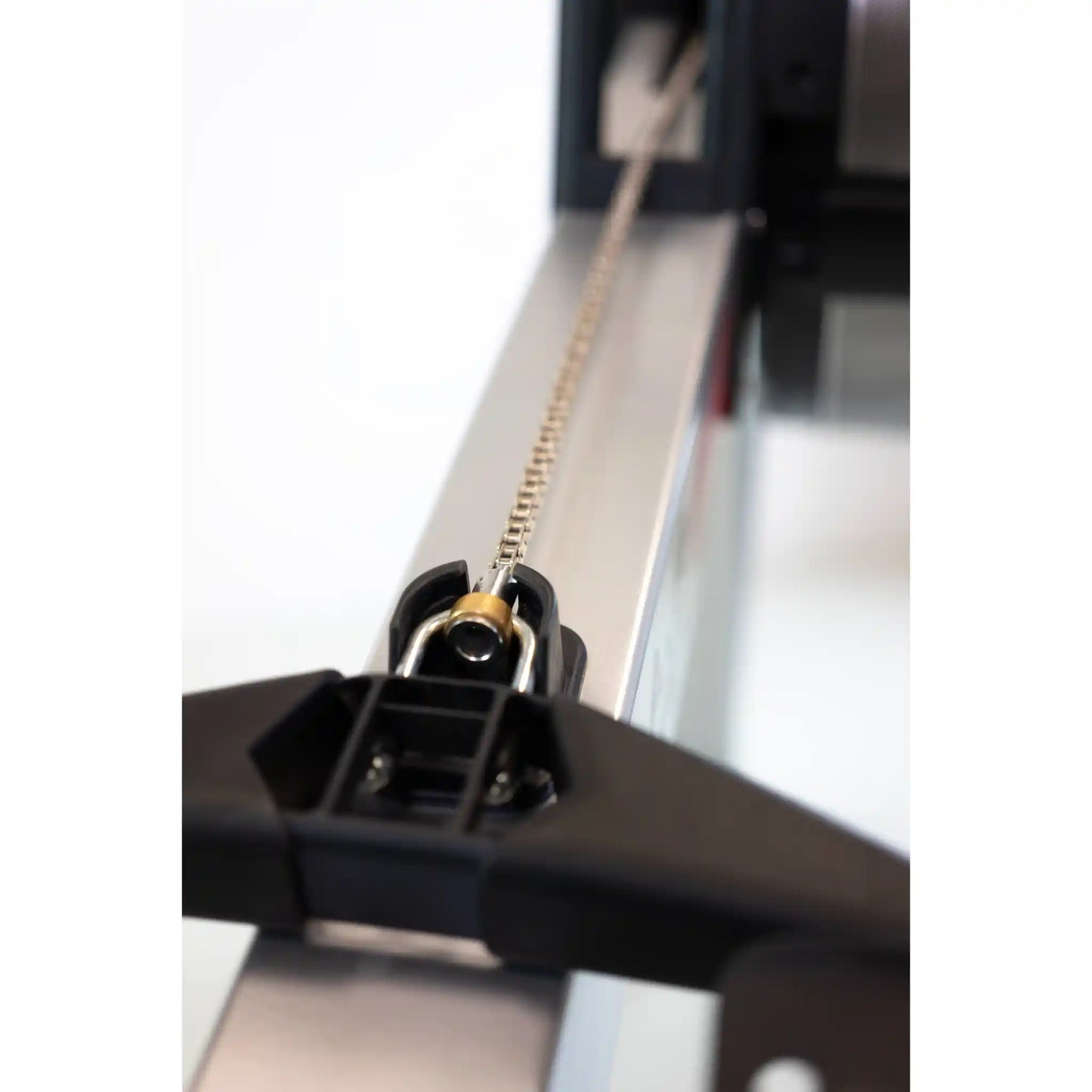 Close-up of a mechanical component with a chain on a white background