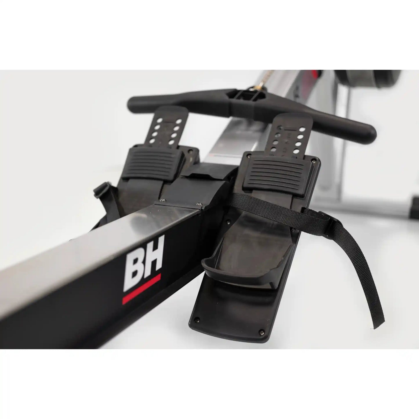 Close-up of a rowing machine with 'BH' branding on a white background