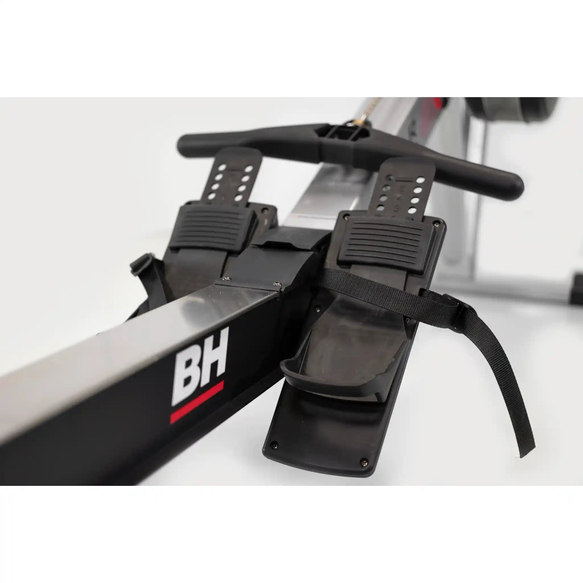 Close-up of a rowing machine with 'BH' branding on a white background