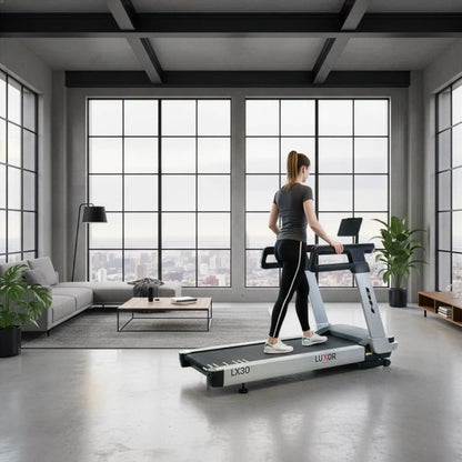 Woman using a treadmill in a modern living room with large windows.