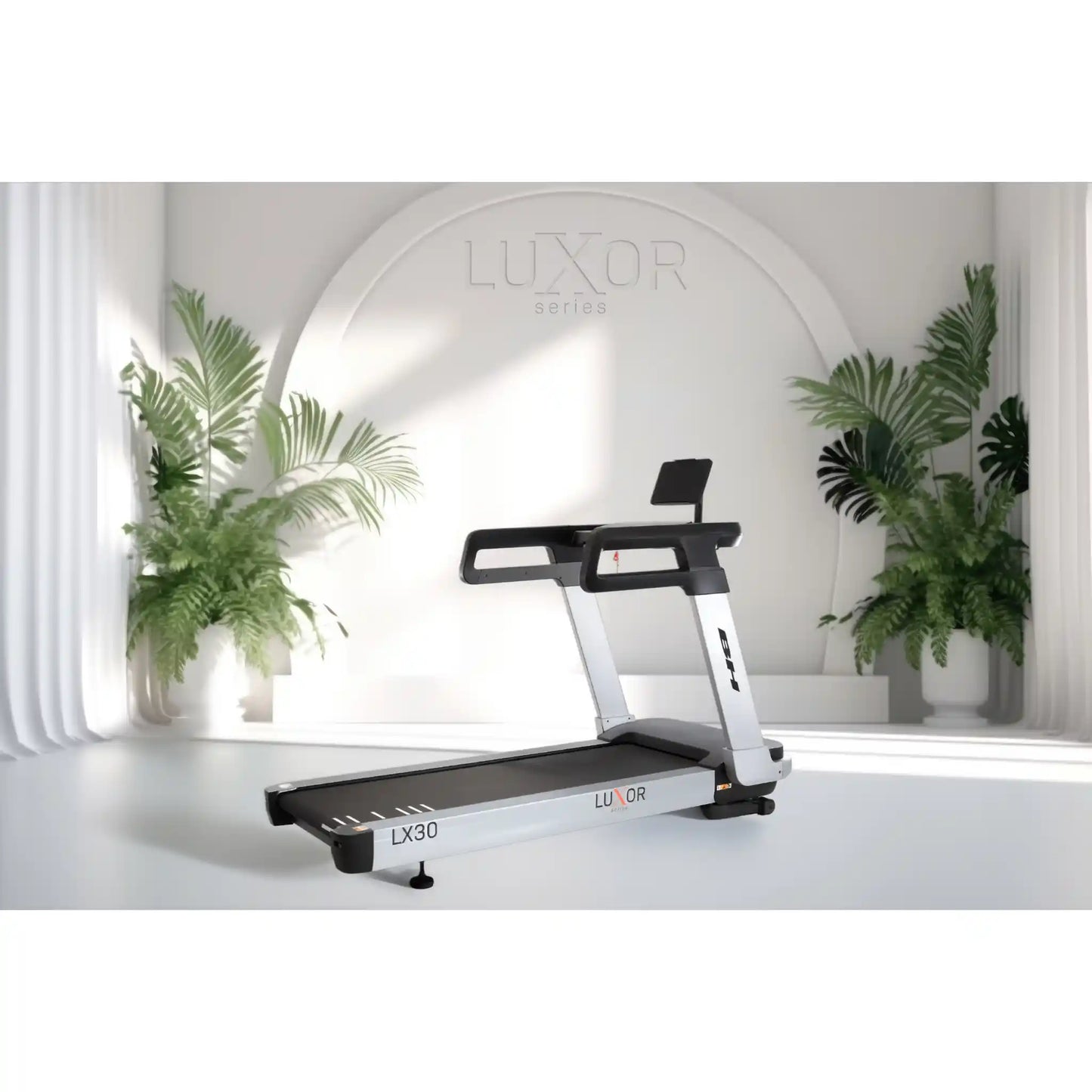 Treadmill with 'Luxor' branding in a modern indoor setting with plants.