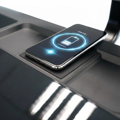 Smartphone with a charging app icon on a black surface