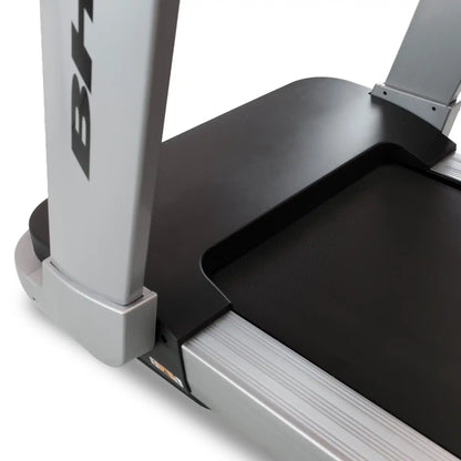 Close-up of a treadmill with a visible brand logo on a white background