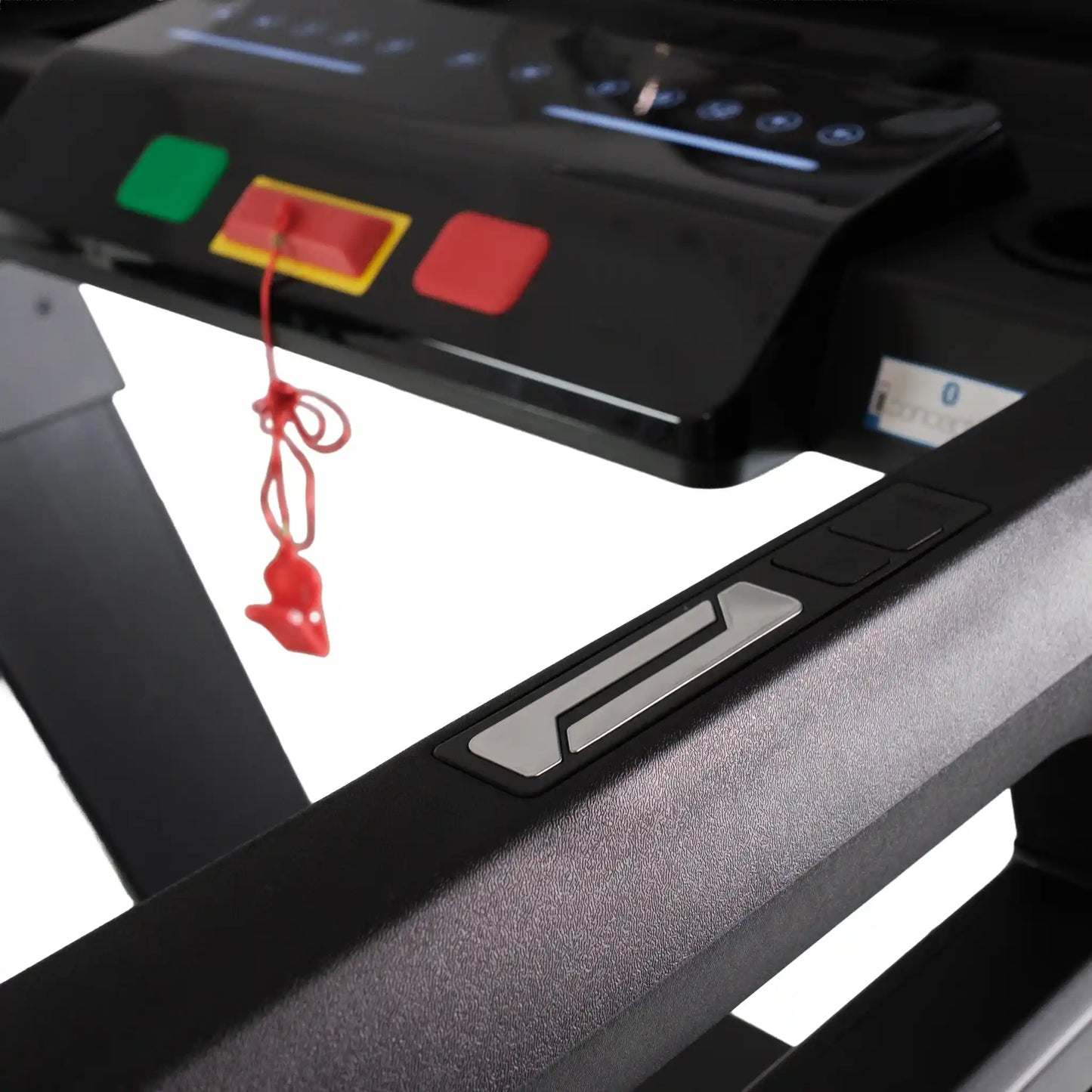 Close-up of a treadmill with control panel and red button