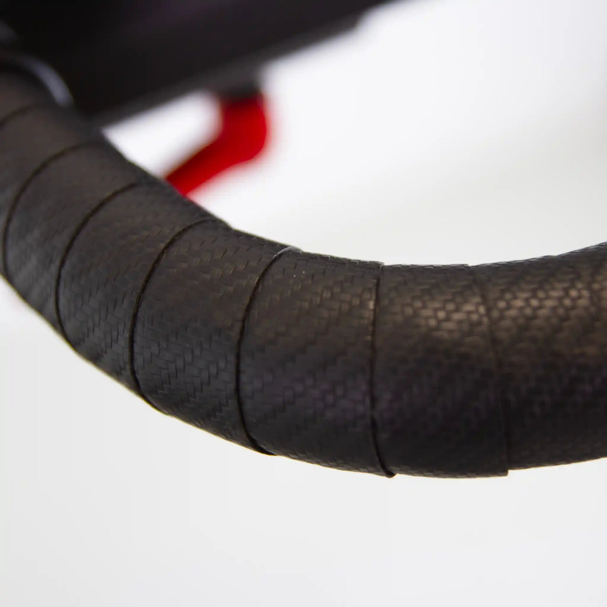 Close-up of a black handlebar on a blurred background