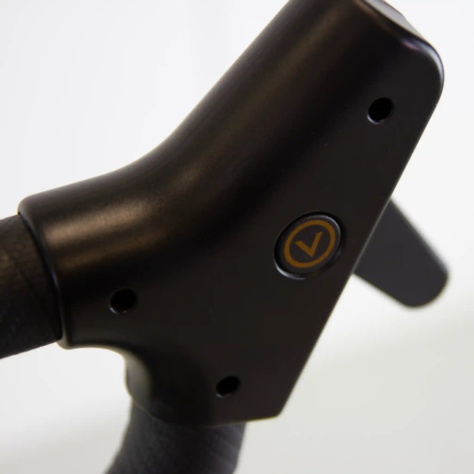Close-up of a black handlebar with a logo on a white background