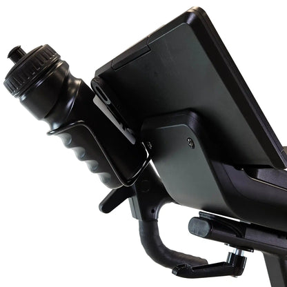 Black water bottle and screen holder on an exercise bike with a white background