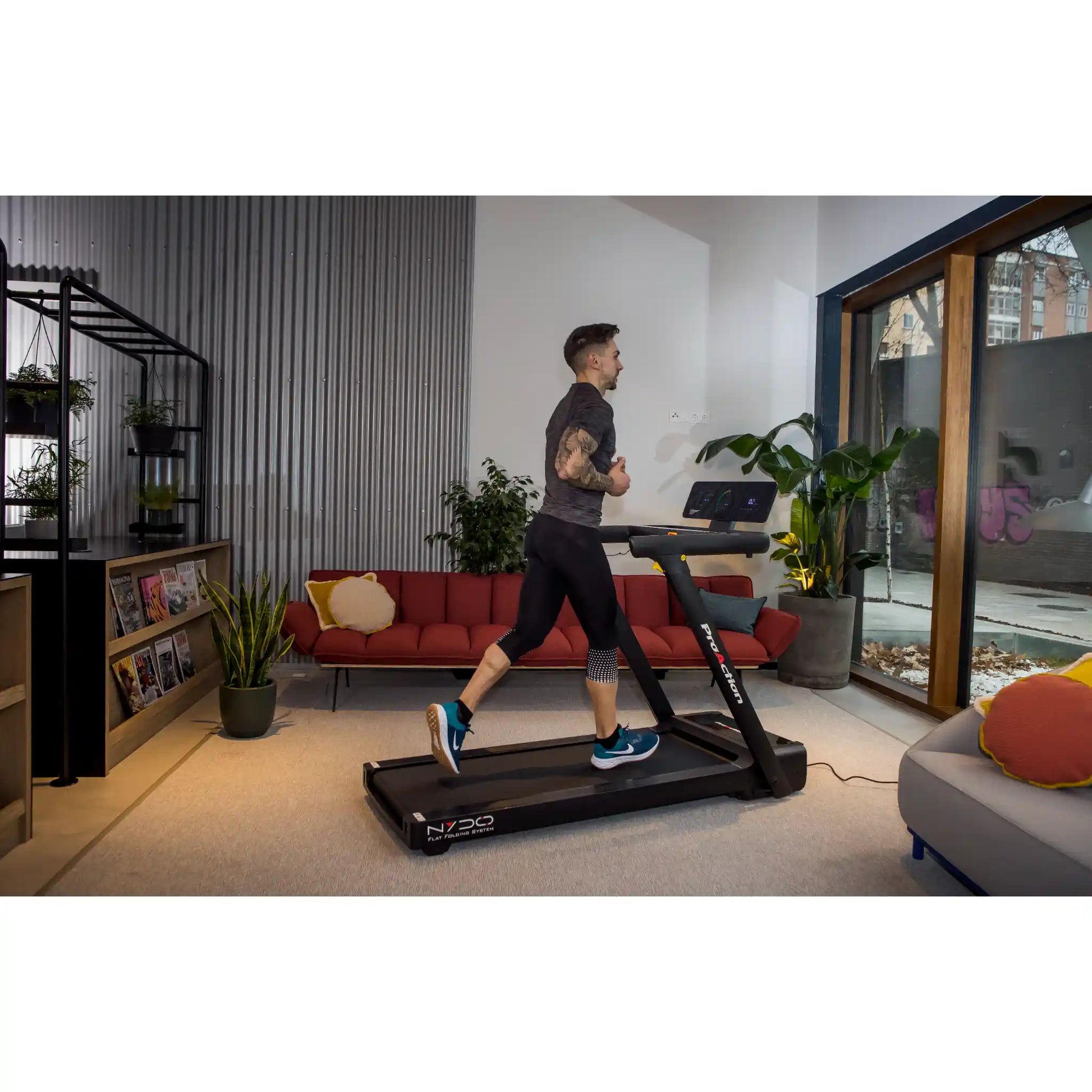 Man running on a treadmill in a modern living room.