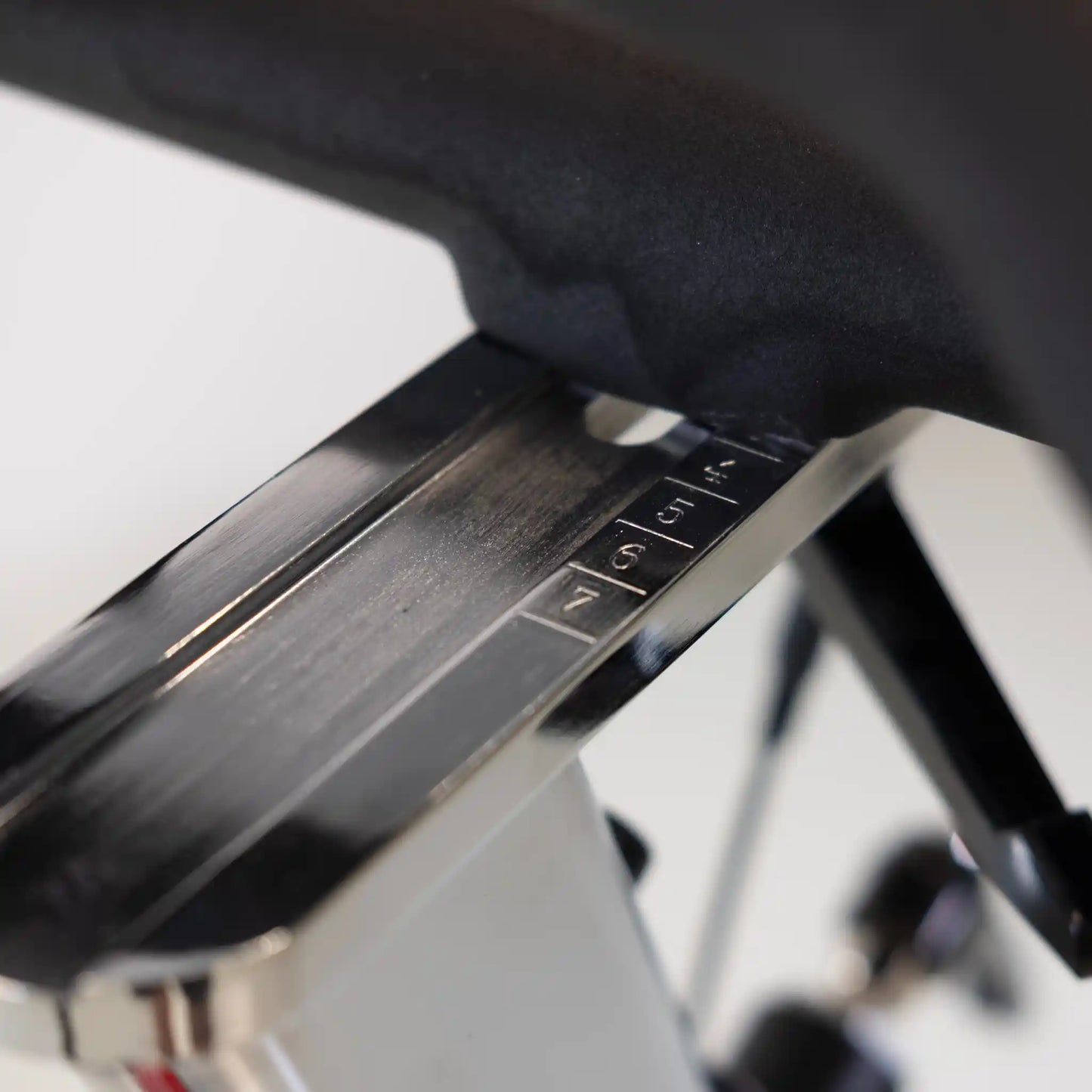 Close-up of a metallic adjustable element with engraved numbers on a blurred background