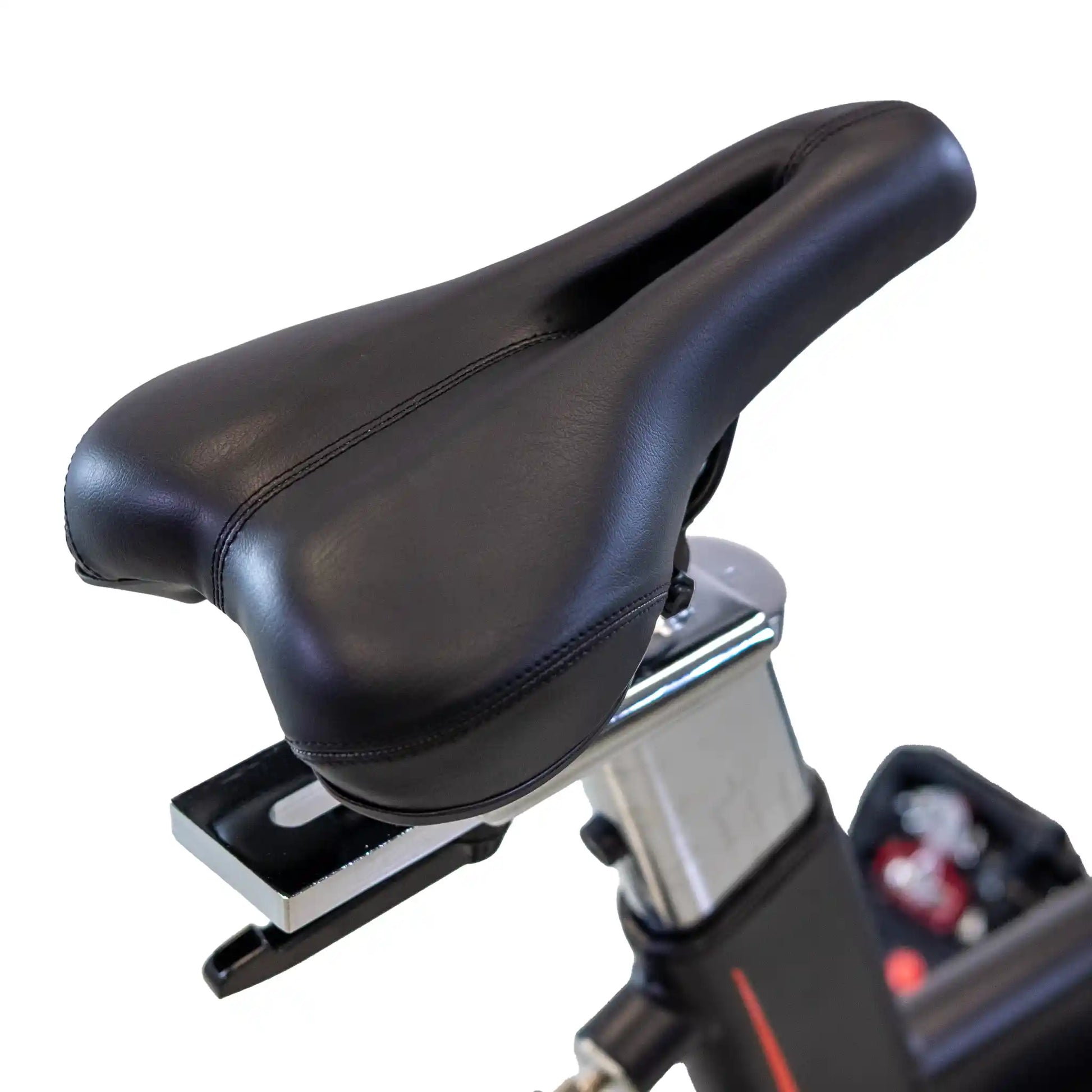 Black bicycle seat on a stationary bike with a white background