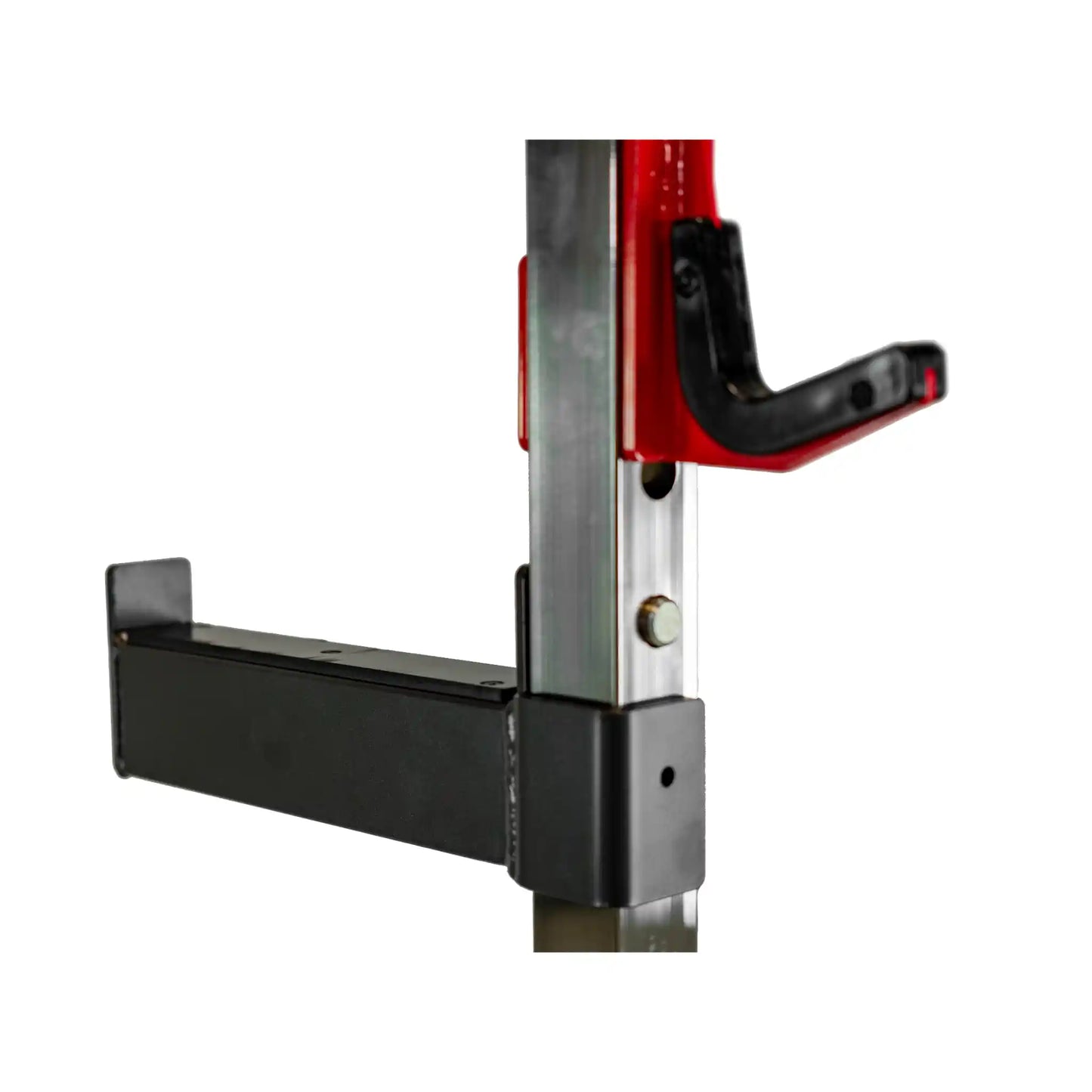 Close-up of a red barbell rest and black safety bar on weight bench