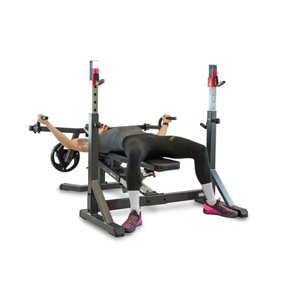 Person using a weight lifting bench and rack on a white background