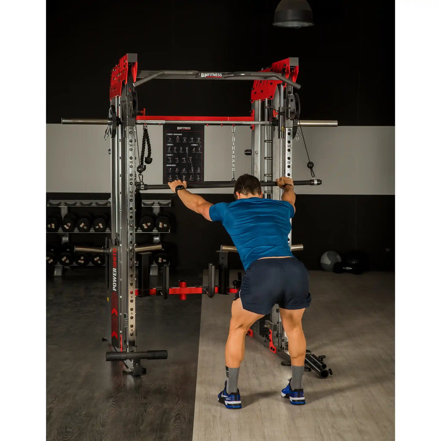 Person using a weightlifting power rack in a gym setting
