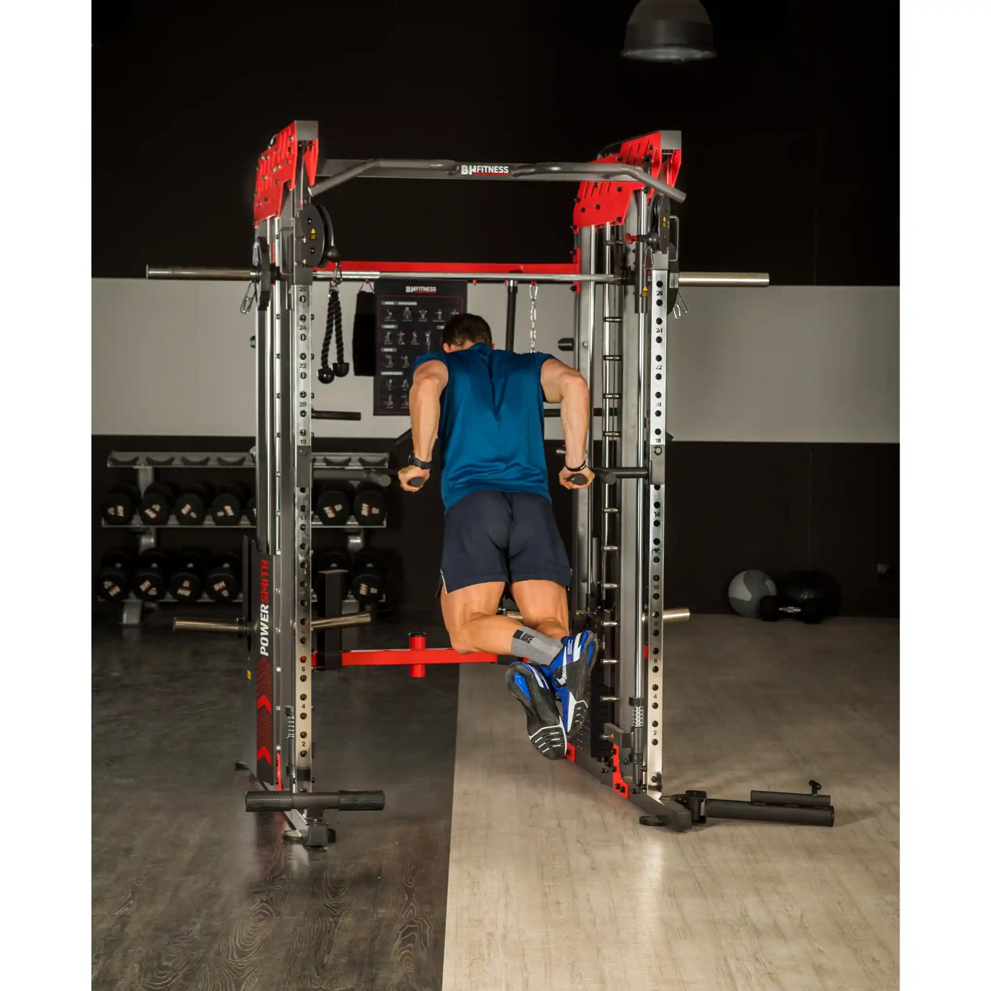 Person using a dip bars on a multi gym in a gym setting