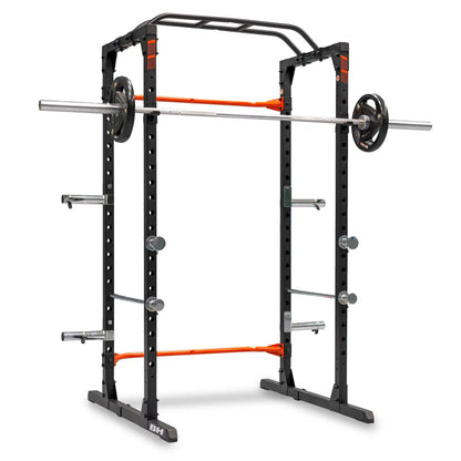 Black weightlifting power rack with orange accents on a white background