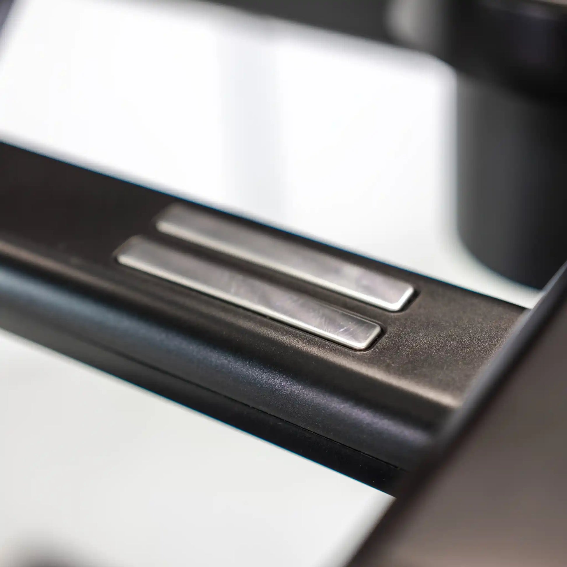 Close-up of a treadmill handle with sensors