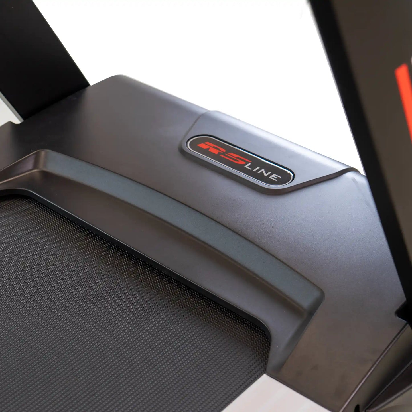 Close-up of a treadmill motor cover with 'RS Line' logo on a white background