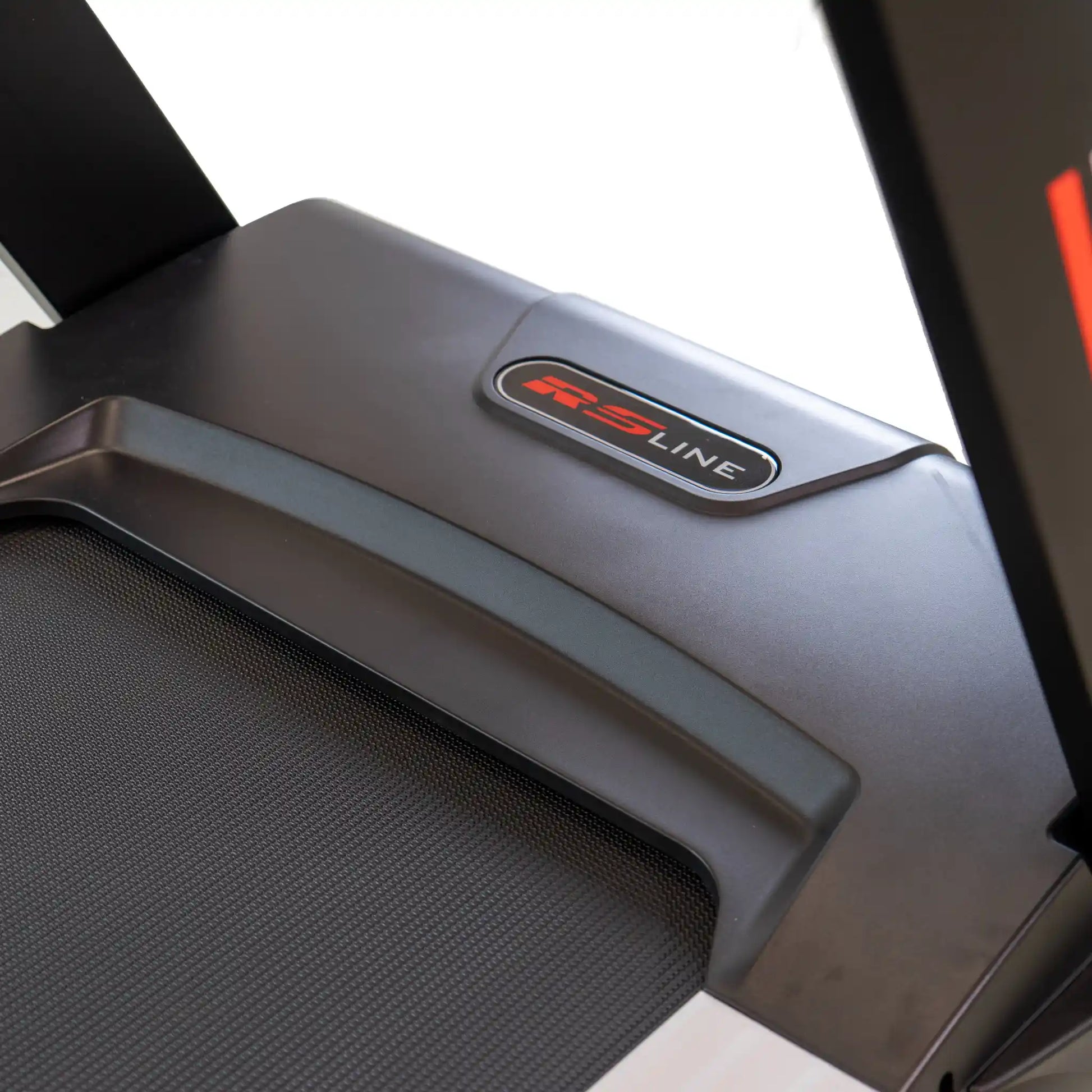 Close-up of a treadmill motor cover with 'RS Line' logo on a white background