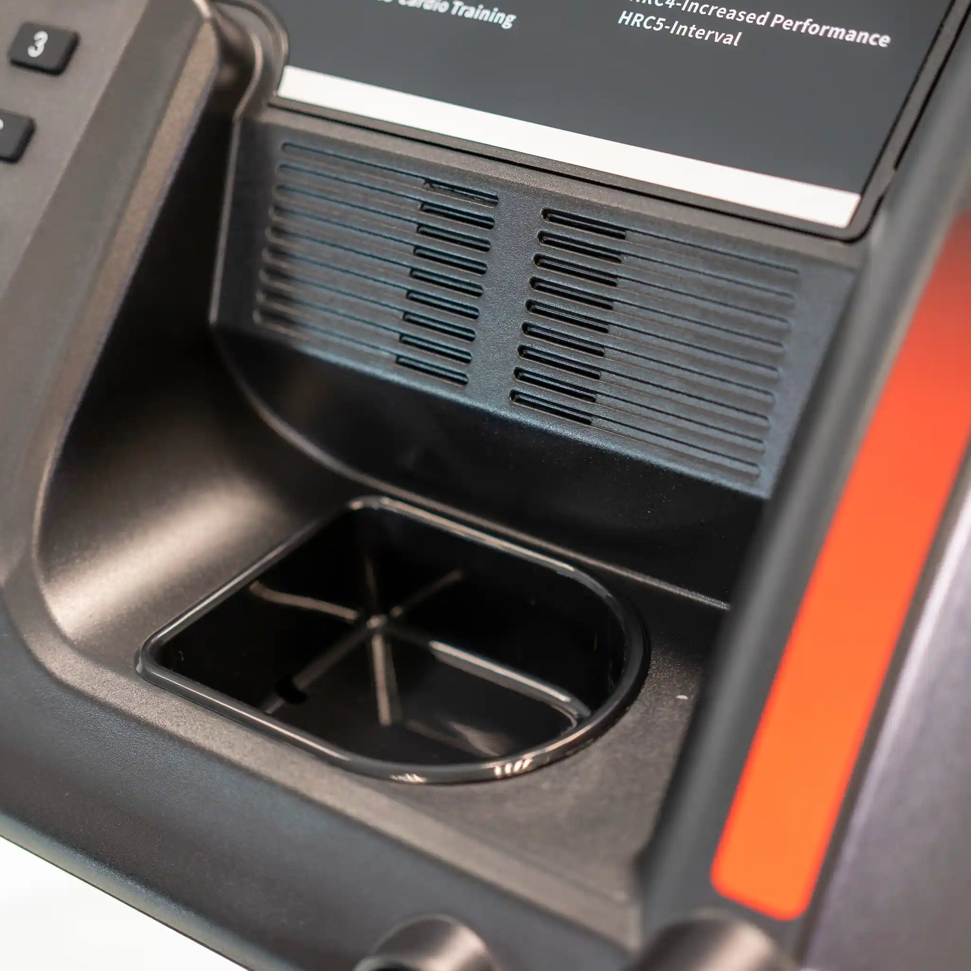 Close-up of a treadmill with a cup holder and digital display.