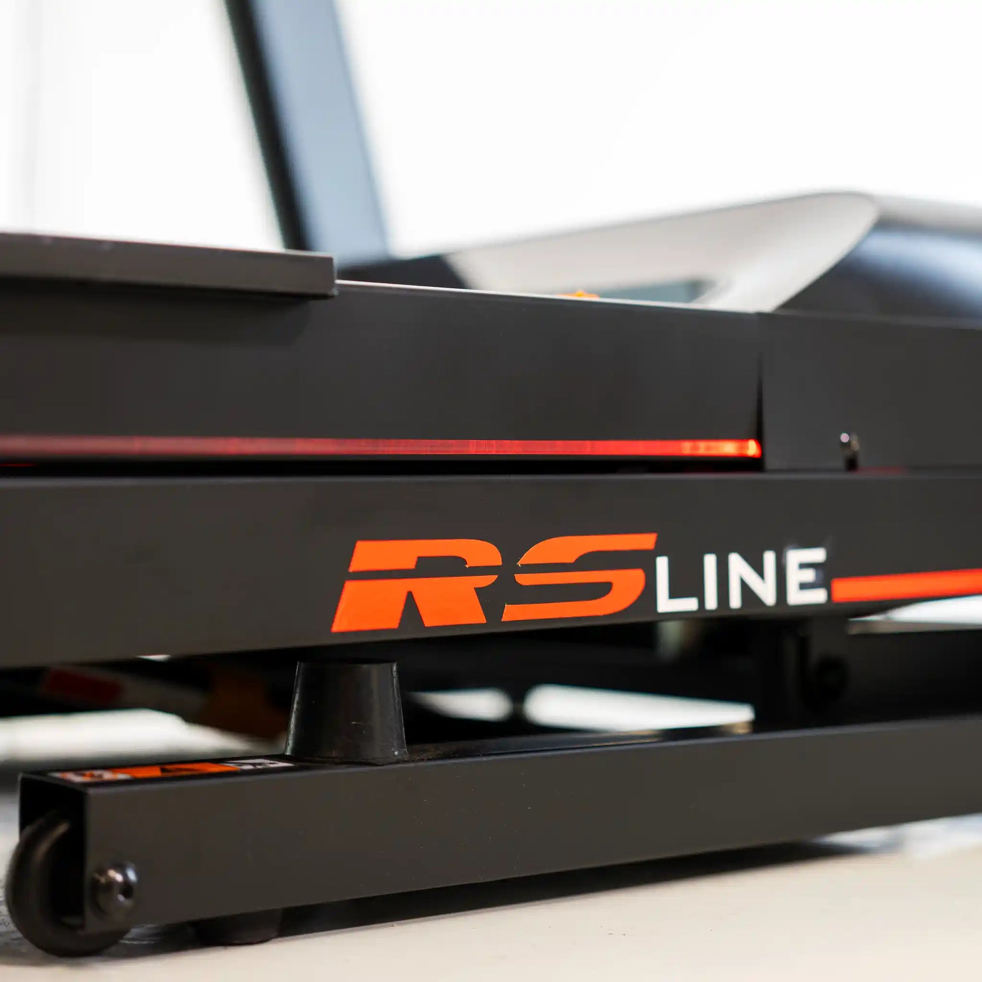 Close-up of a side of treadmill with 'RS Line' branding.