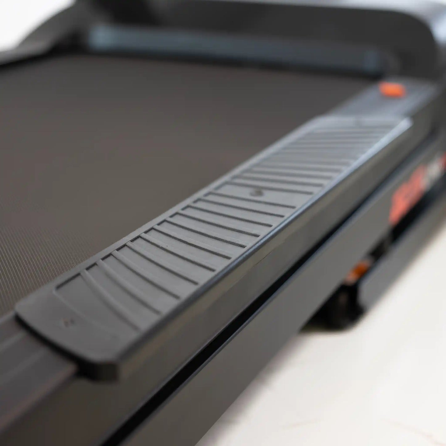 Close-up of a treadmill with a blurred background