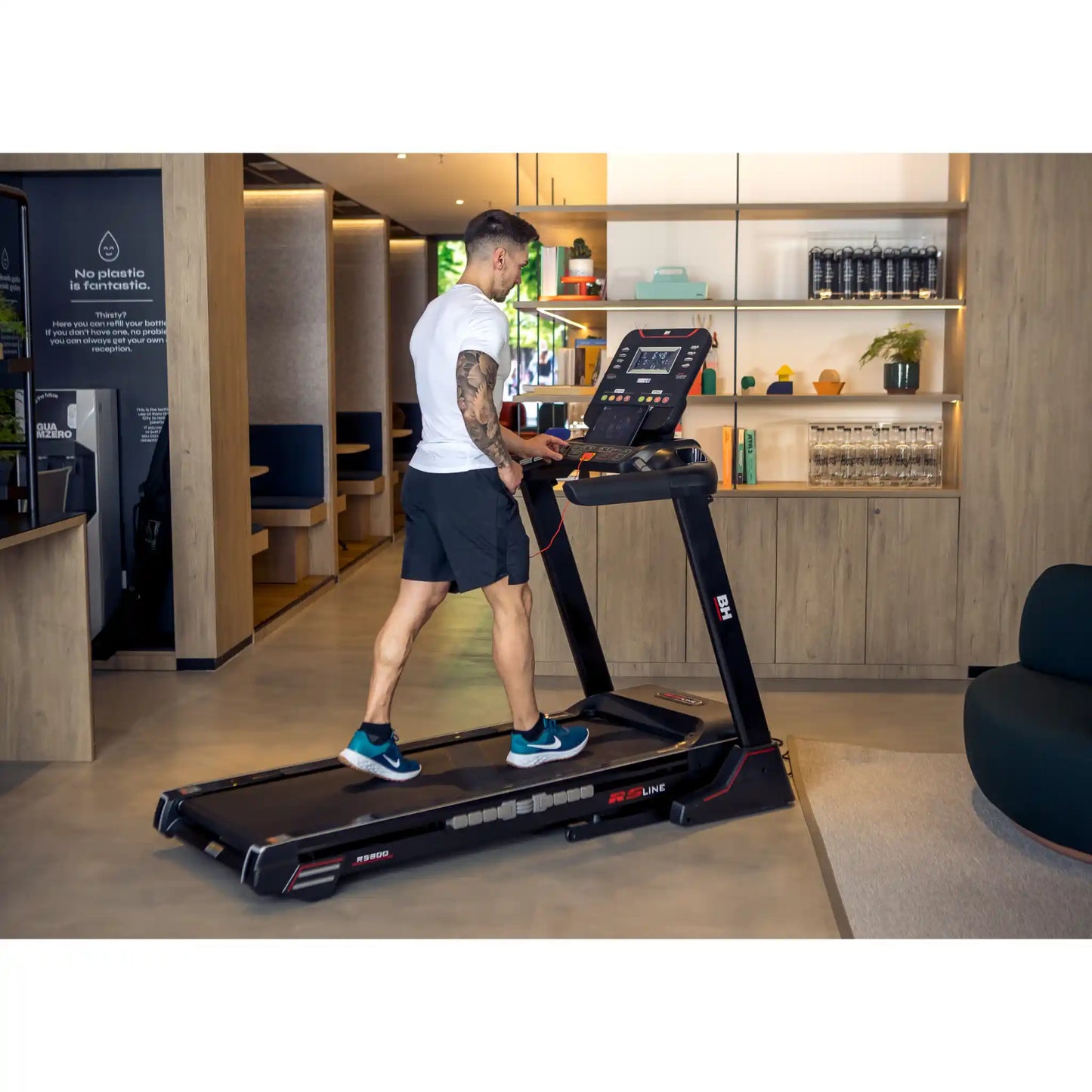 Man using a treadmill in a modern indoor setting