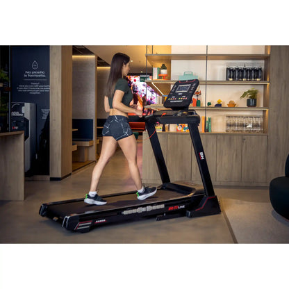 Woman using a treadmill in a modern indoor setting