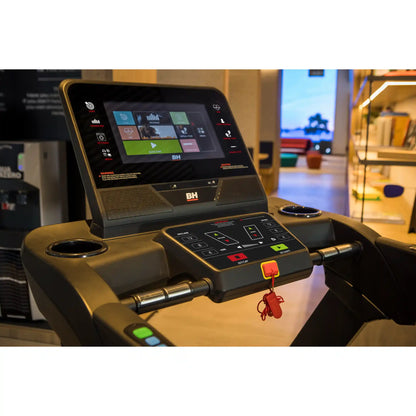 Treadmill multimedia console with digital display and control buttons in a gym setting