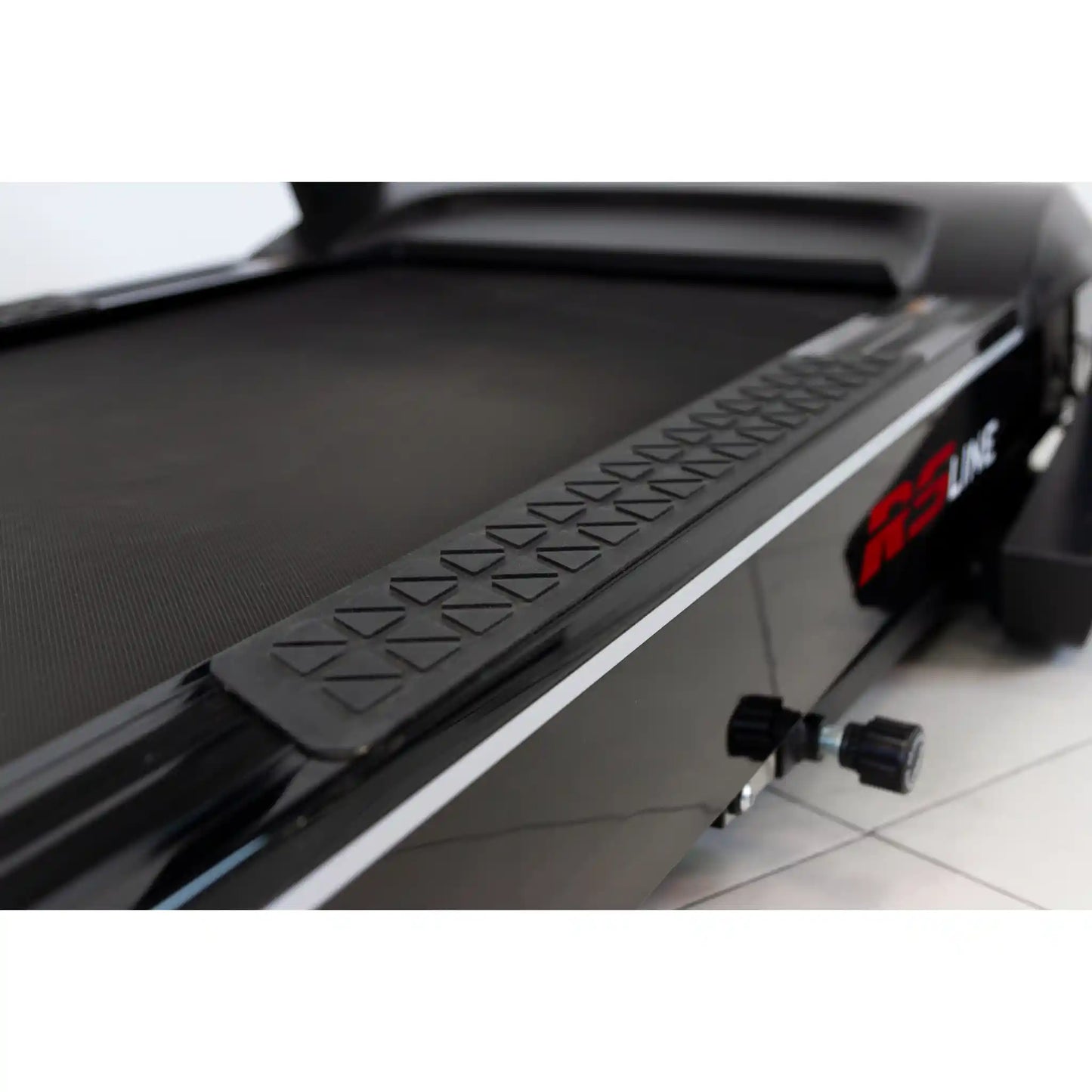 Close-up of a treadmill with a step platform and RS Line branding.