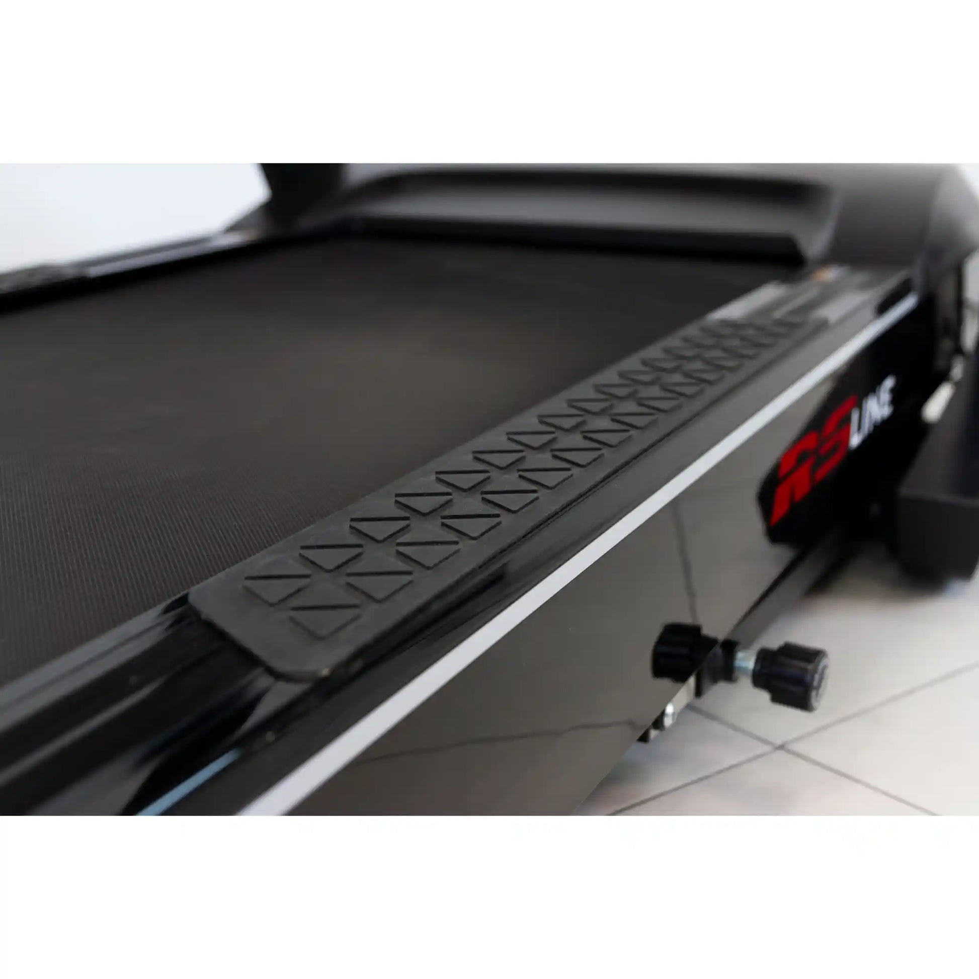 Close-up of a treadmill with a step platform and RS Line branding.