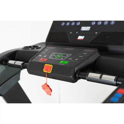 Close-up of a treadmill control panel with digital display and buttons.