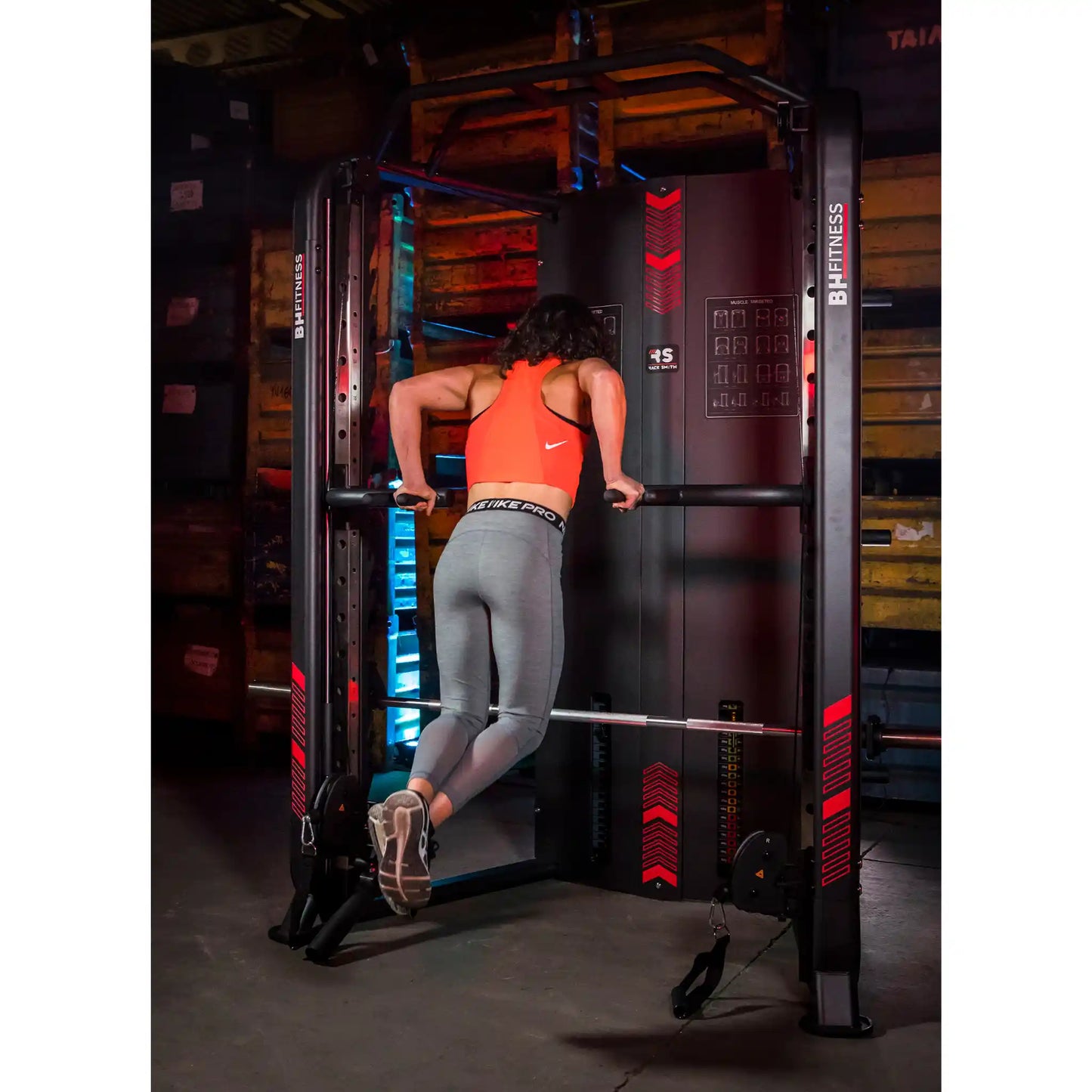Person using a fitness machine in a gym setting