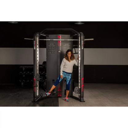 Woman using a pulley system on multi gym in a gym setting