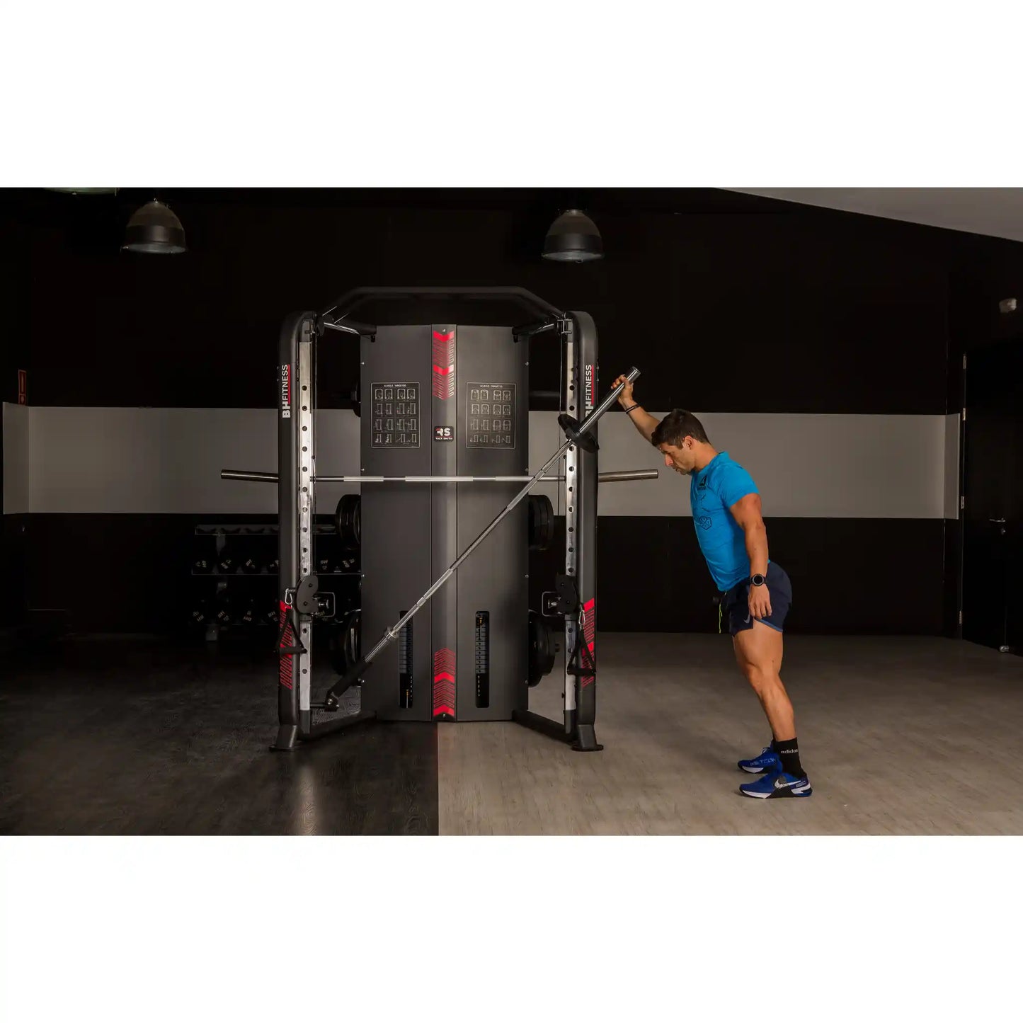 Person using landmine barbell machine in a gym setting