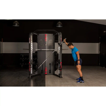 Person using landmine barbell machine in a gym setting