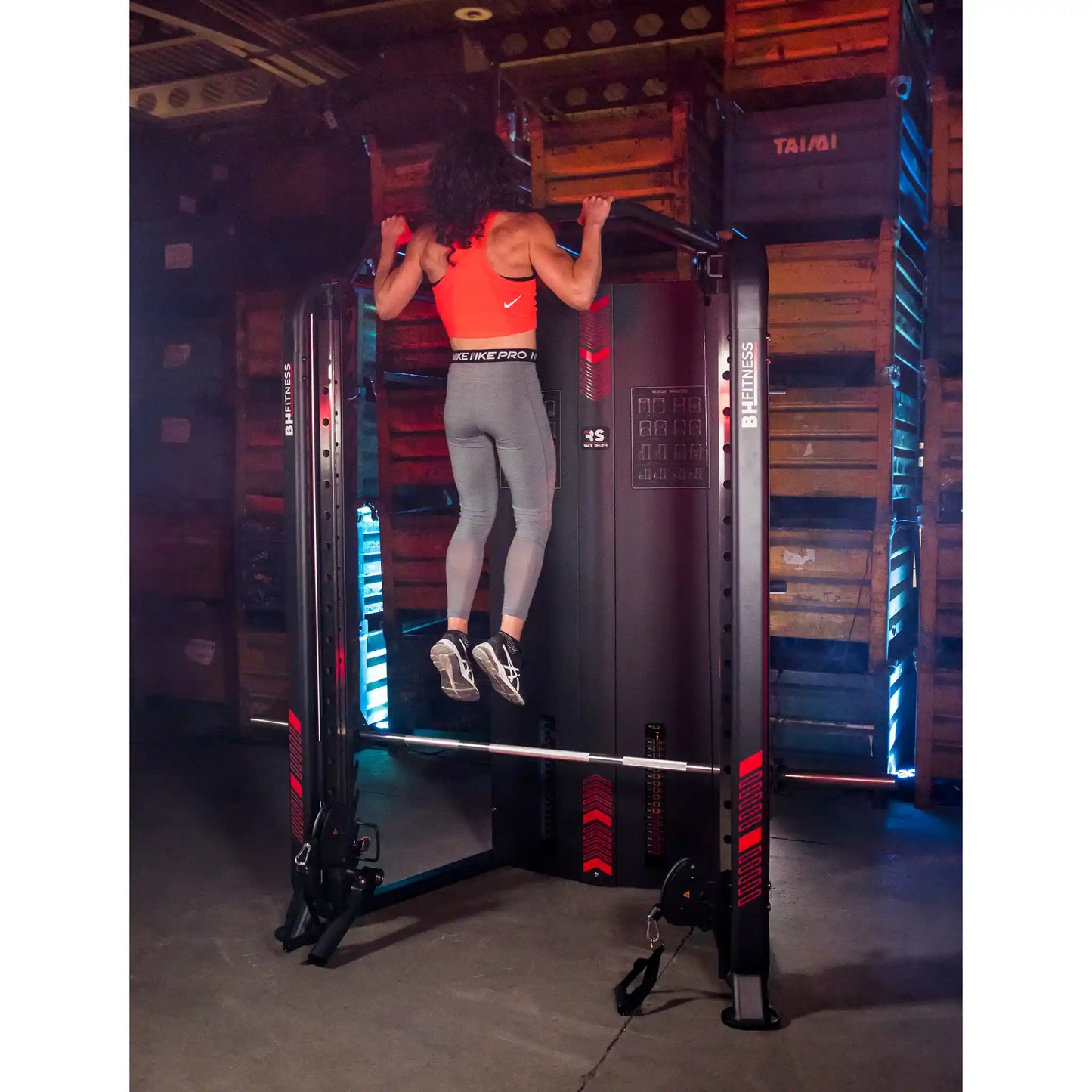 Person doing a pull-up on a multi gym in a gym setting