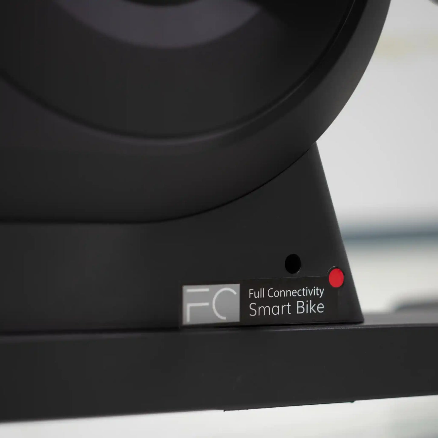 Close-up of bottom support of a black bike component with 'Full Connectivity Smart Bike' label.