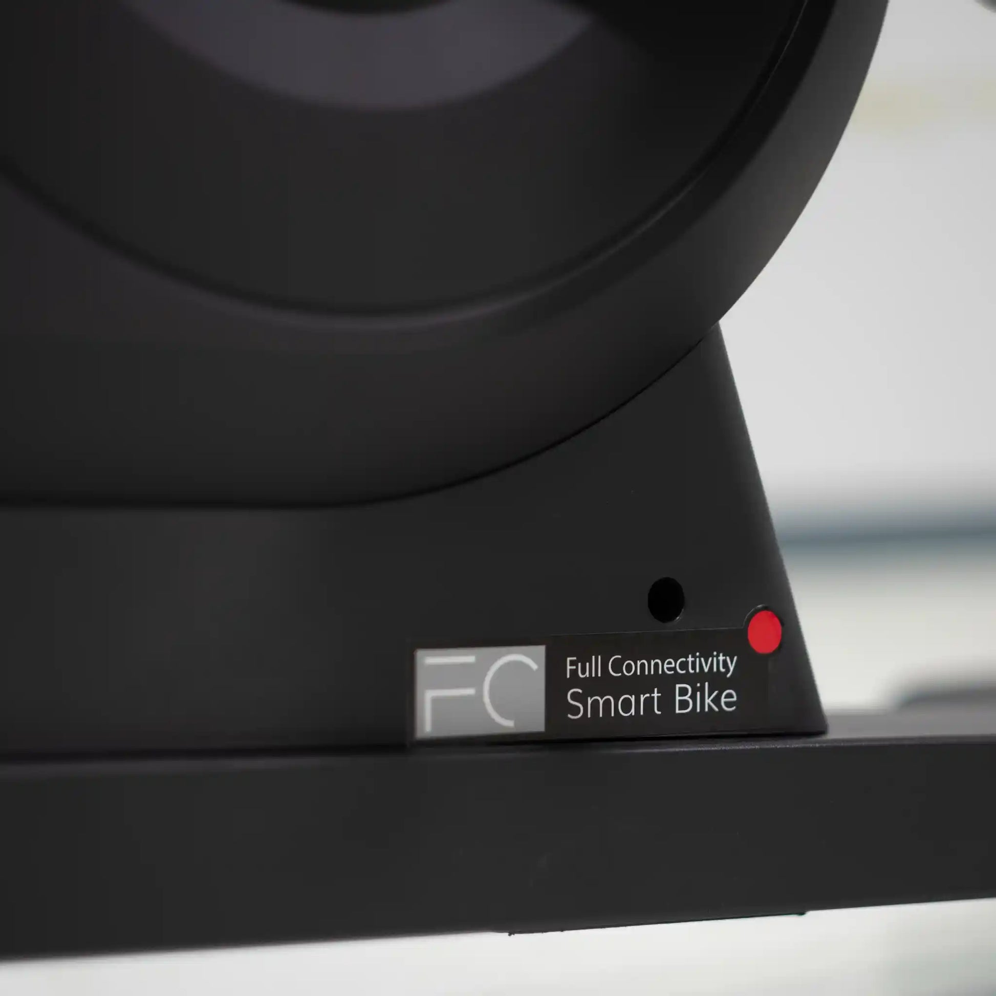 Close-up of bottom support of a black bike component with 'Full Connectivity Smart Bike' label.