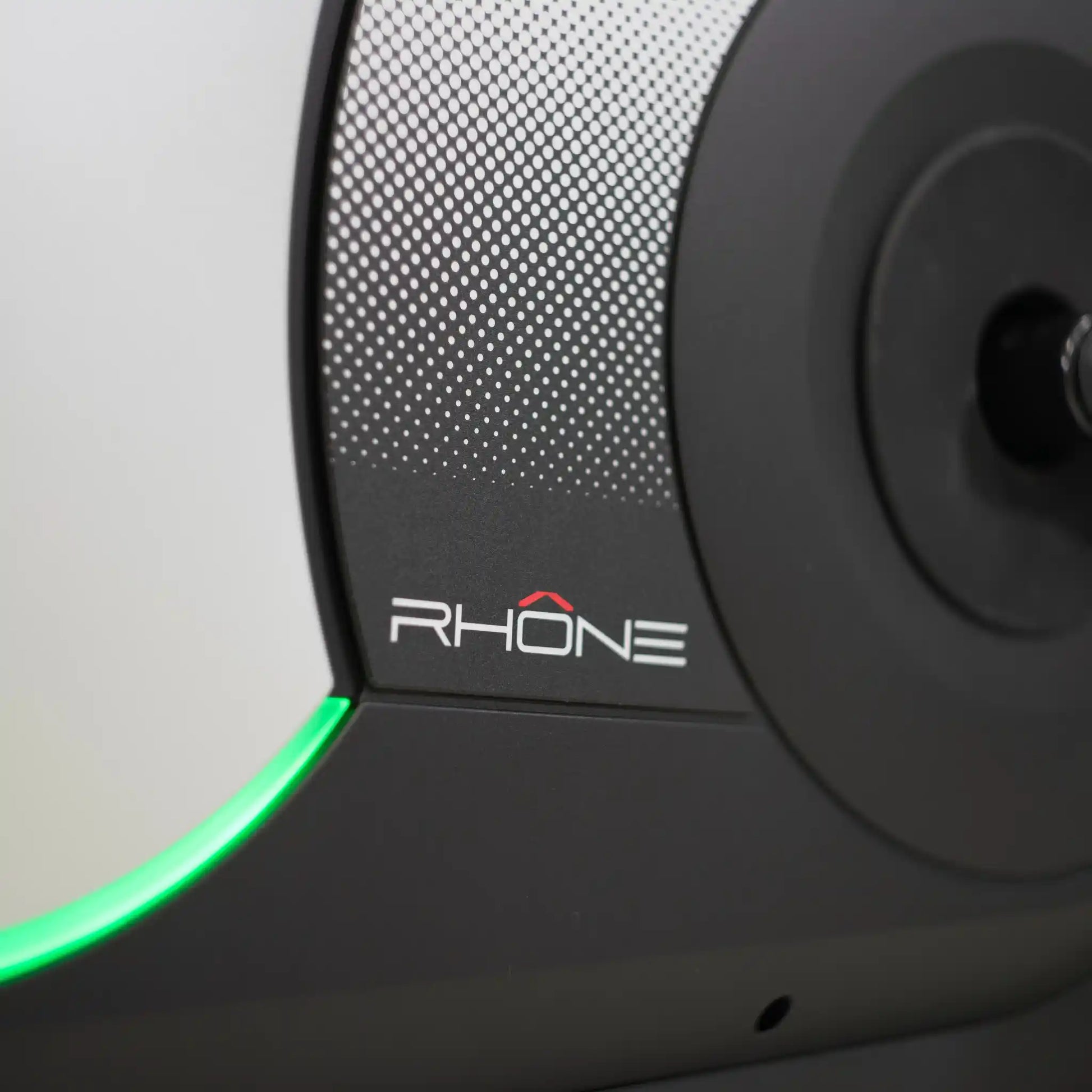 Close up of exercise bike fly wheel with Rhone branding