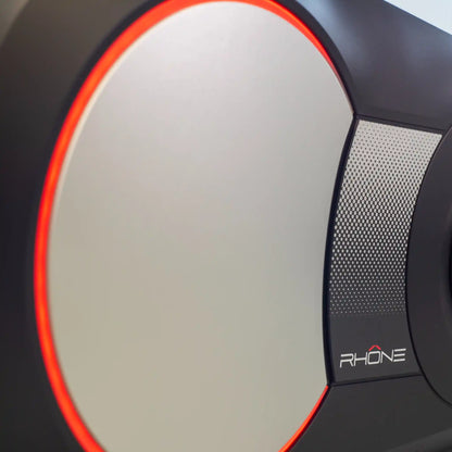 Close-up of exercise bike fly wheel with a red light on a white background