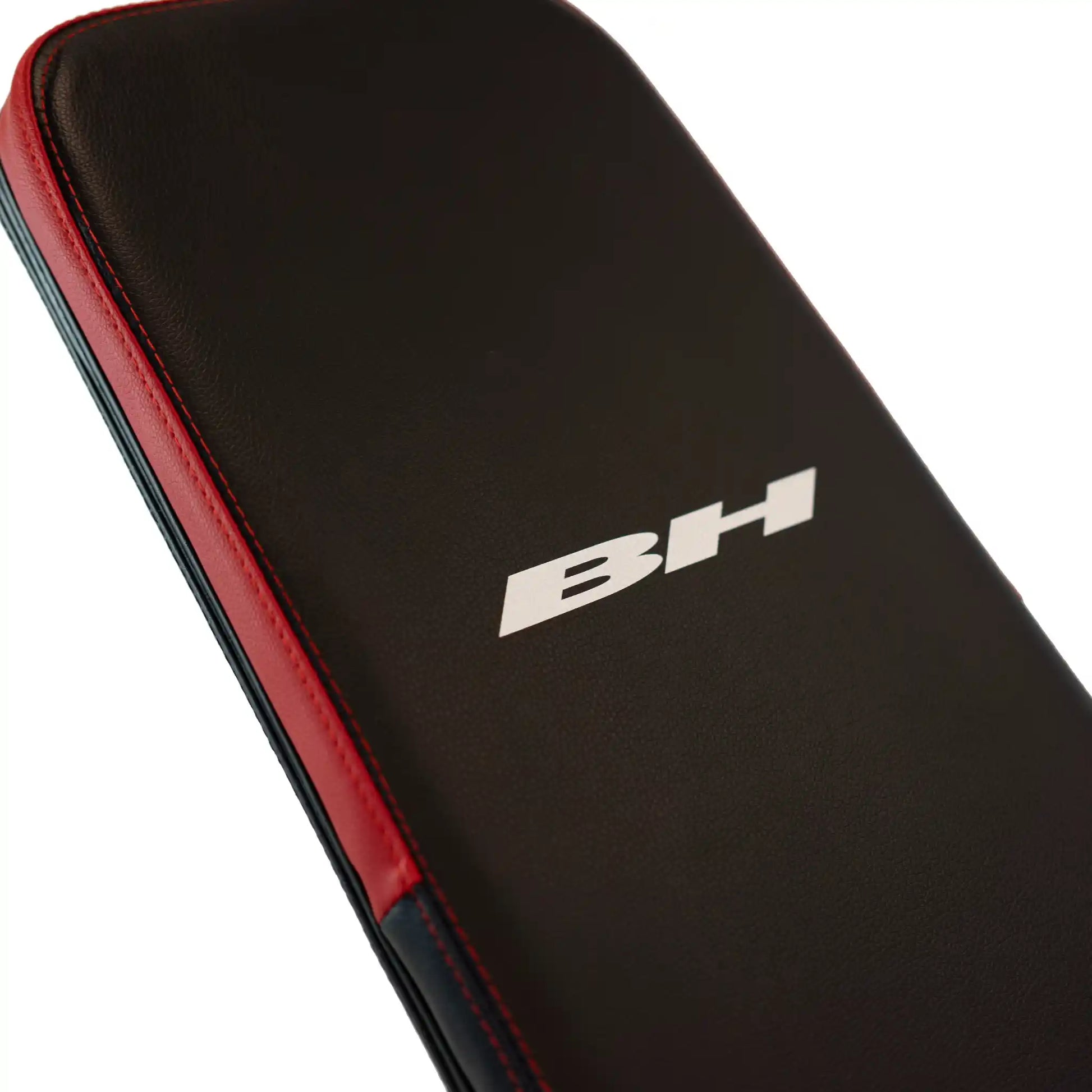 Back support on black and red weight bench with BH branding