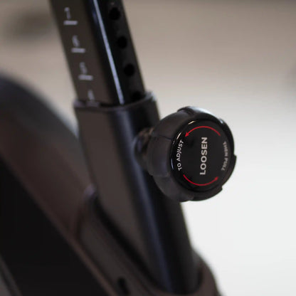 Close-up of a exercise bike seat height with a adjustment knob.