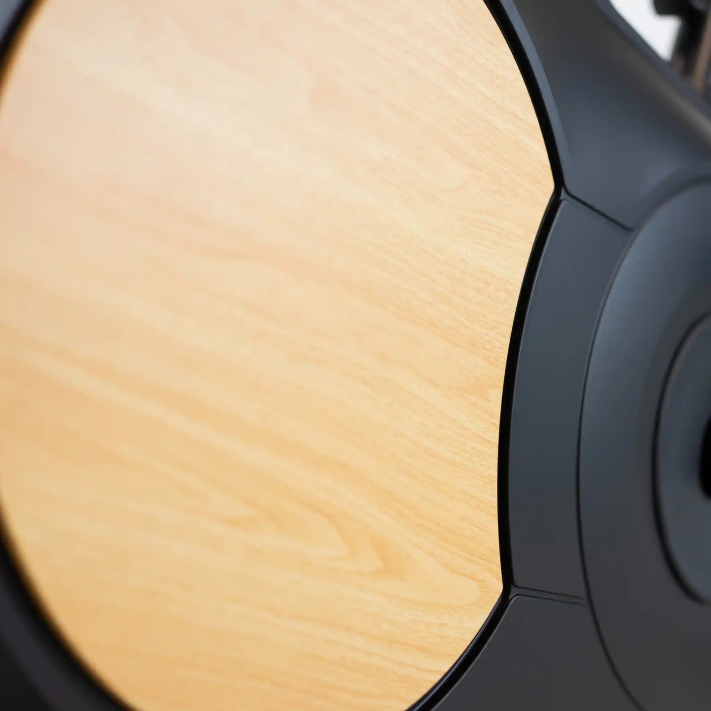 Close-up of exercise bike motor with a wood effect finish. 